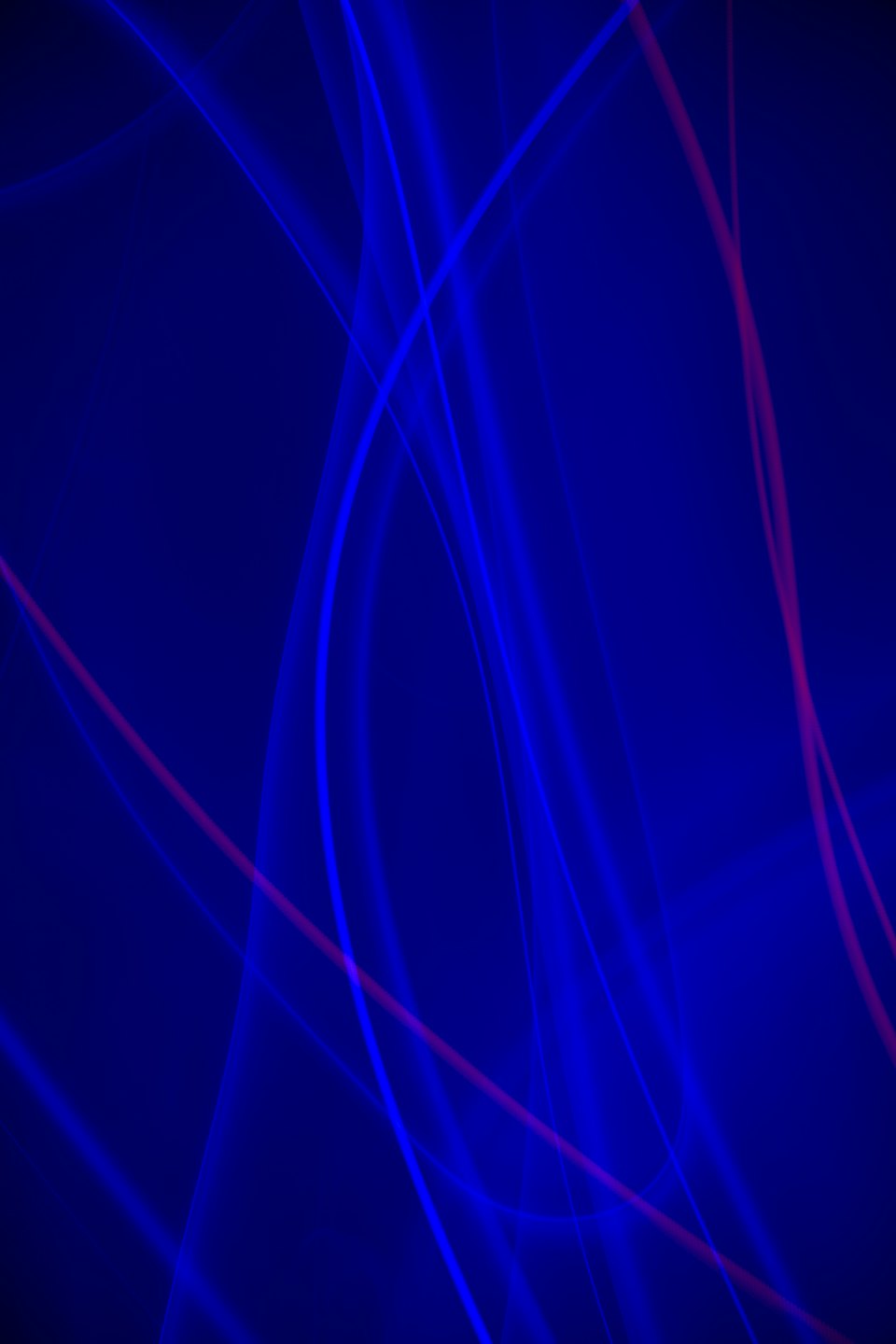 Flowing blue and magenta light lines create a dynamic pattern.